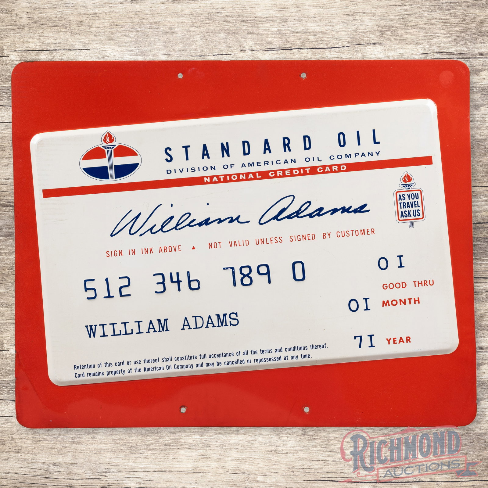 Standard American Oil Company Single Sided Tin Credit Card Sign: SST (single sided tin) embossed sign has excellent color and shine. The field has light storage wear with paper marks. The perimeter has similar wear with bends along the lower left corner. All in all