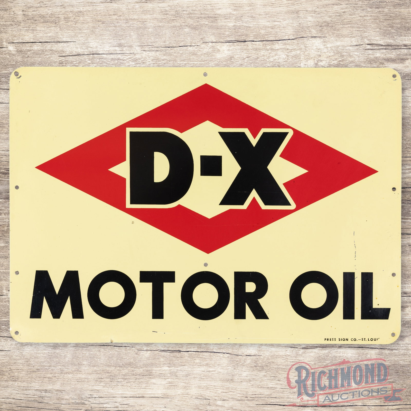 D-X Motor Oil Single Sided Tin Logo Sign: SST (single sided tin) sign has excellent color and shine. The field is clean with minor surface imperfections. The outer fields and perimeter have small fine scratches and paint chips. Marked Press S