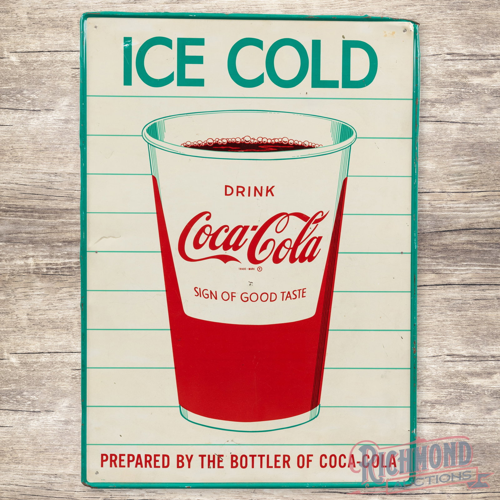 Ice Cold Drink Coca Cola Single Sided Tin Sign w/ Cup: SST (single sided tin) self-framed sign has excellent color and shine. The display has light wear with small paint chips, a few small dimples and light bends throughout. The perimeter has marks with s