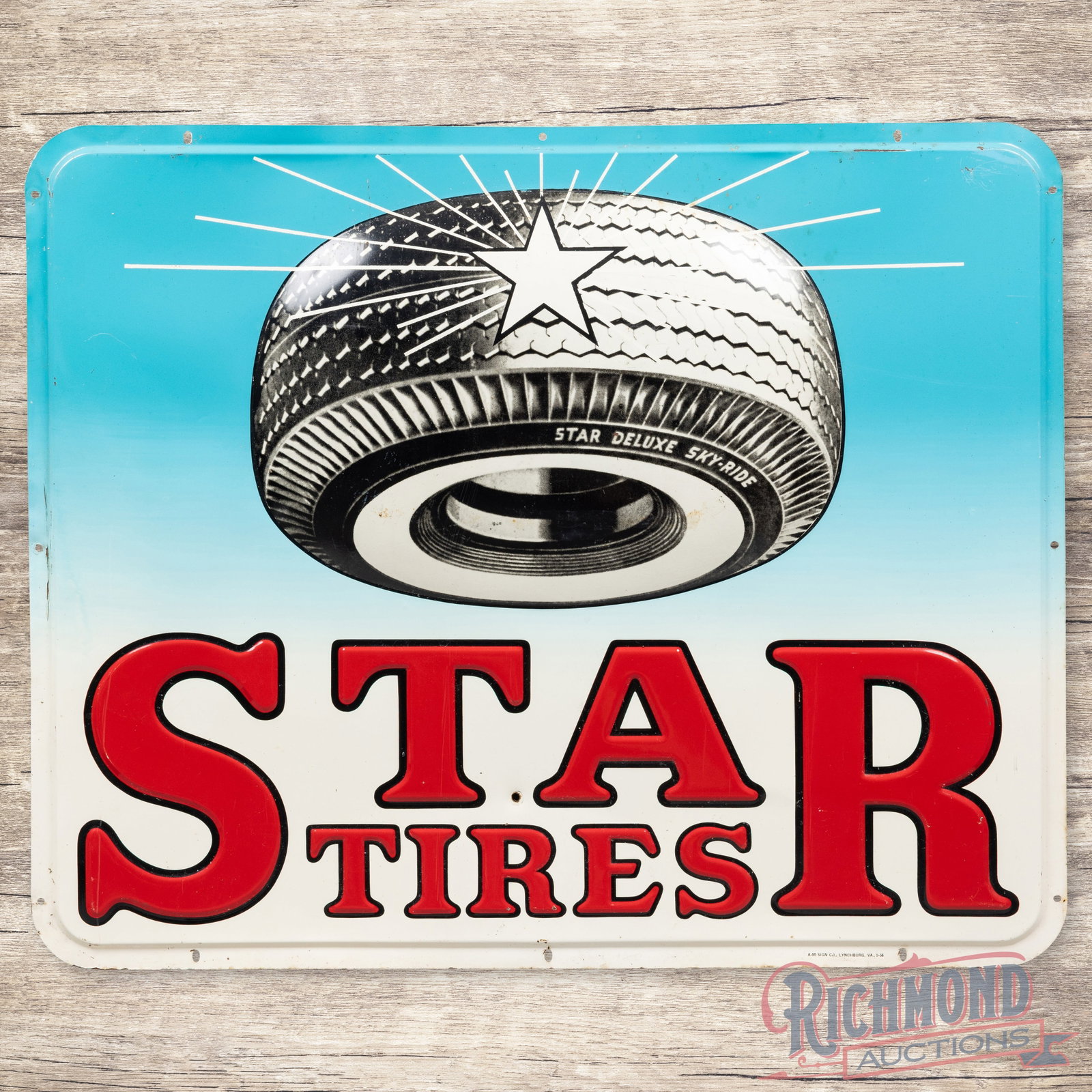 1956 Star Tires Heavily Embossed Single Sided Tin Sign w/ Sky-Ride Tire: SST (single sided tin) heavily embossed sign has very good color and shine. The display has light war with small paint chips and minor oxidation. The lower field has a non-factory hole between the "T 