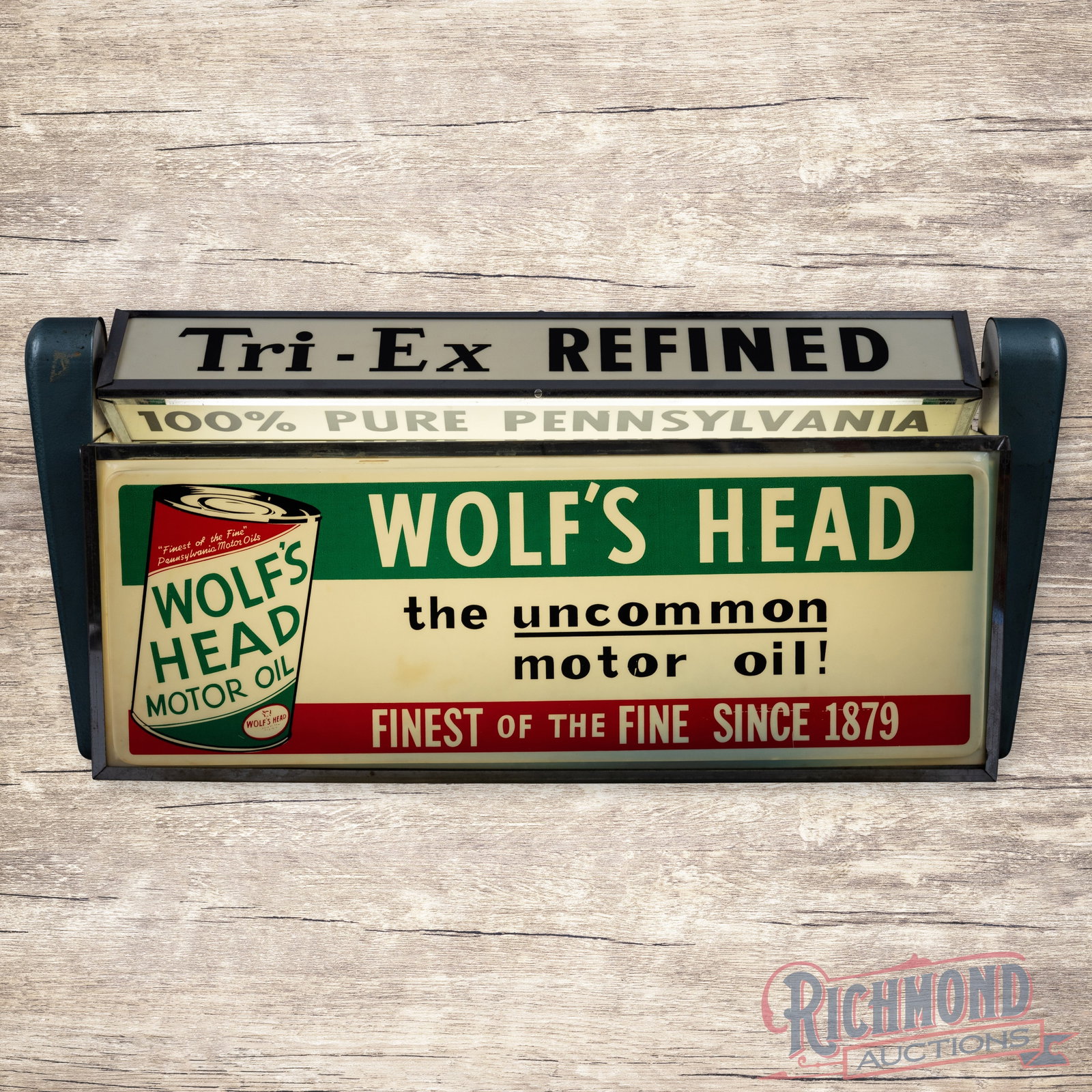 Scarce Wolf's Head Motor Oil Lighted Motion Advertising Sign: Outstanding internally lighted sign with rotating three-sided marquee has excellent color. The lighted portion and upper marquee rotates properly. The main Wolf's Hed plastic sign panel is in very goo