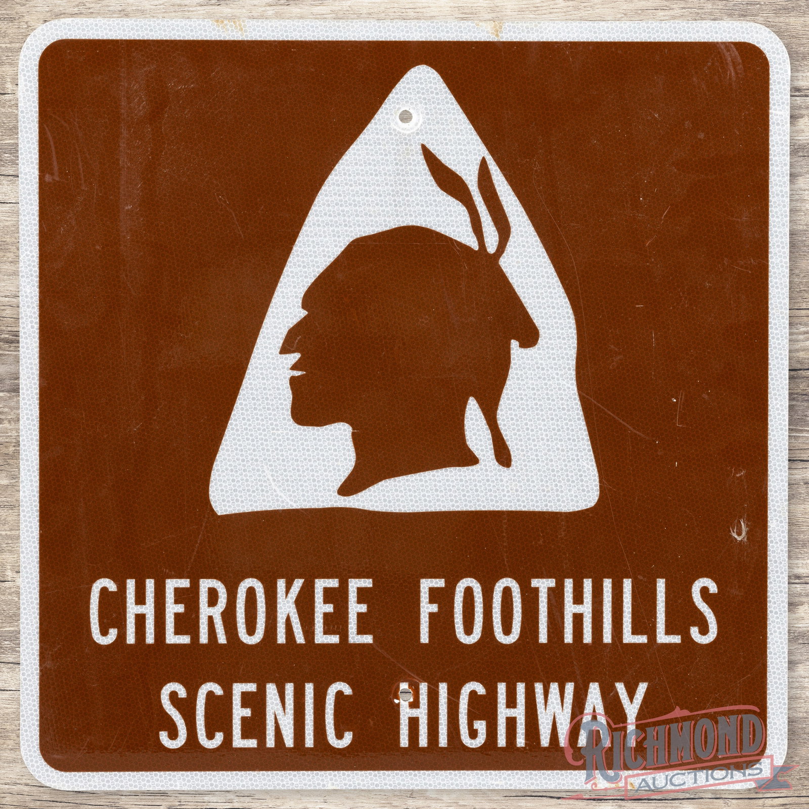 Cherokee Foothills Scenic Highway 24" Reflective Single Sided Tin Sign w/ Native American: Single sided aluminum sign with reflective sheeting has excellent color. The display has light wear with fine scratches. The perimeter has wear at the mounting holes with minor discoloration along the