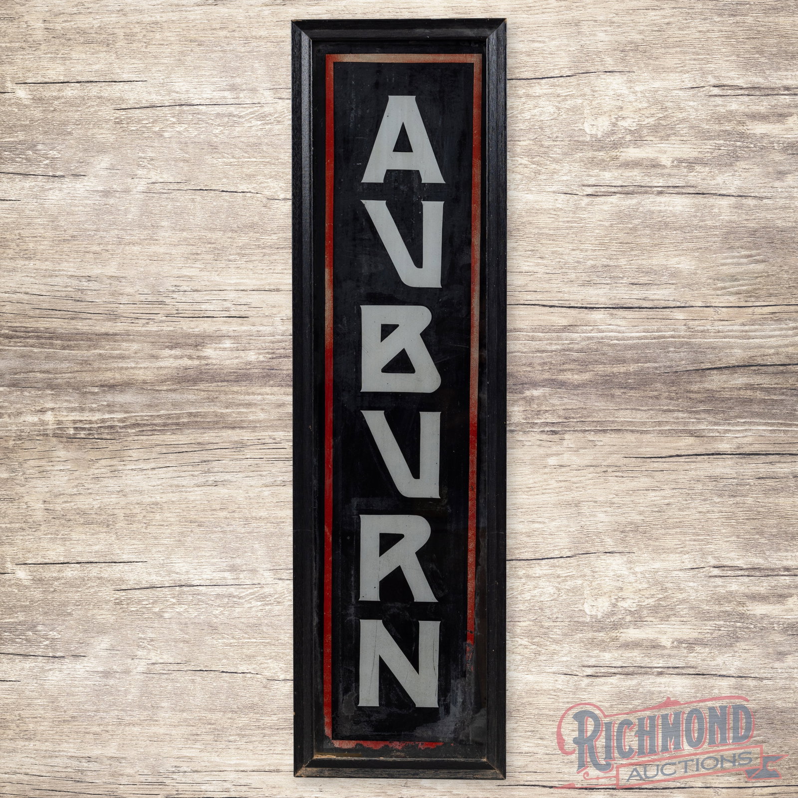 Auburn Automobiles Reverse on Glass 4' Sign: Reverse on glass sign with an added wooden frame has good color. The display has areas of wear with flaking and discoloration. The perimeter has similar wear with some loss along the lower edges. The 