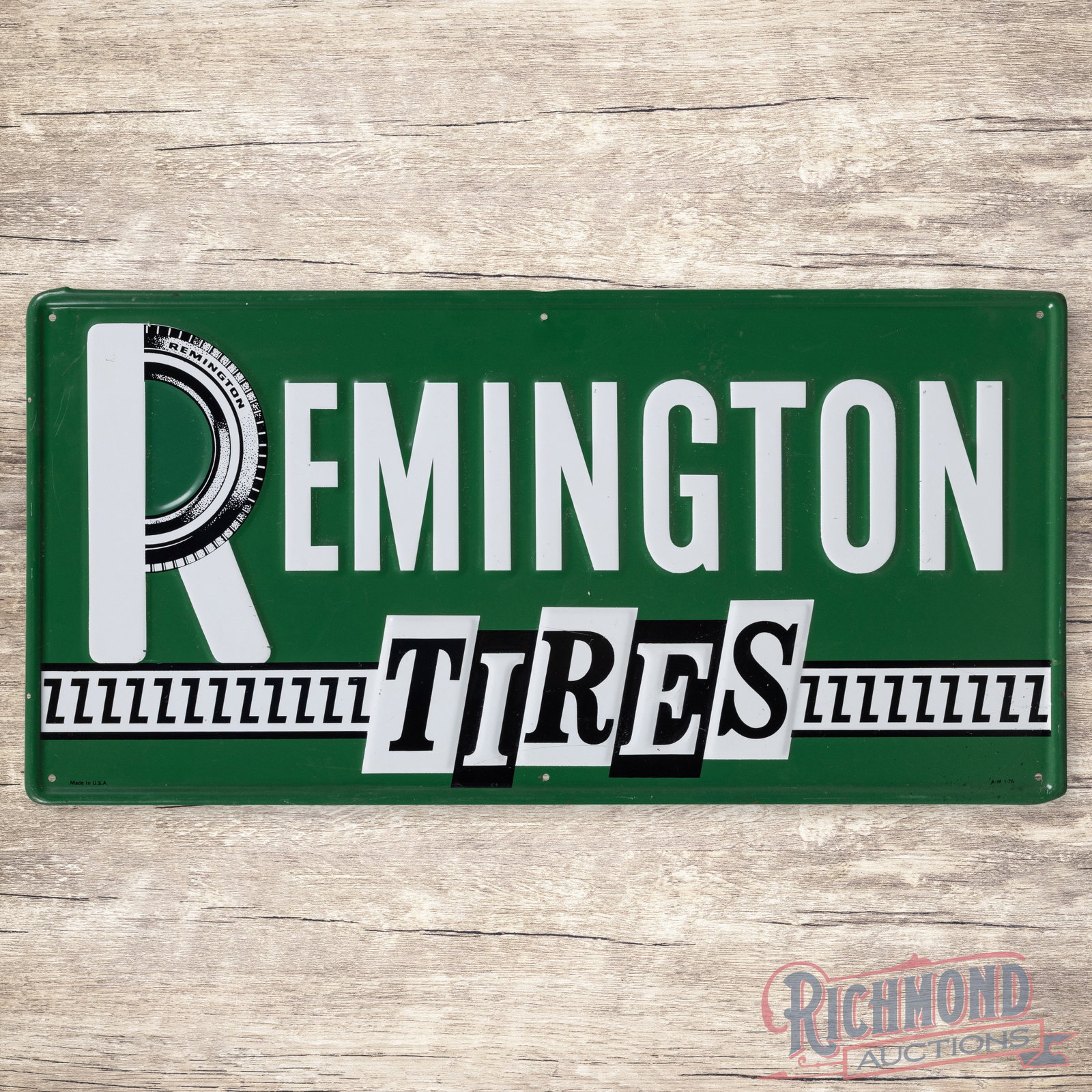 Remington Tires Emb. Single Sided Tin Sign: SST (single sided tin) embossed self-framed sign has excellent color and shine. The display has light wear with fine scratches and a minor indentation to the right of the "S" in Tires. The perimeter h