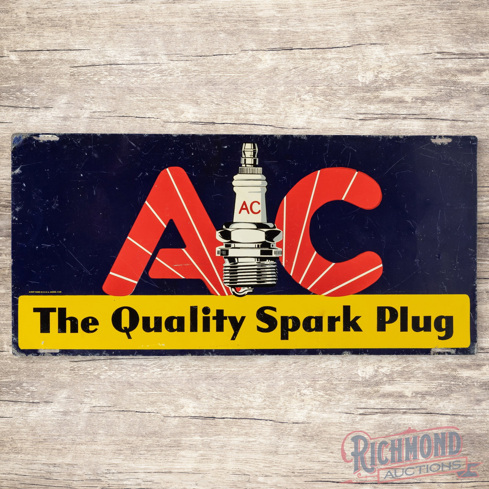 1938 AC The Quality Spark Plug Single Sided Tin Sign: SST (single sided tin) sign has good color and shine. The display has small dings, faint bends and fine scratches. The perimeter has edge wear with oxidation, paint chips and bends. Marked A-1637 Made