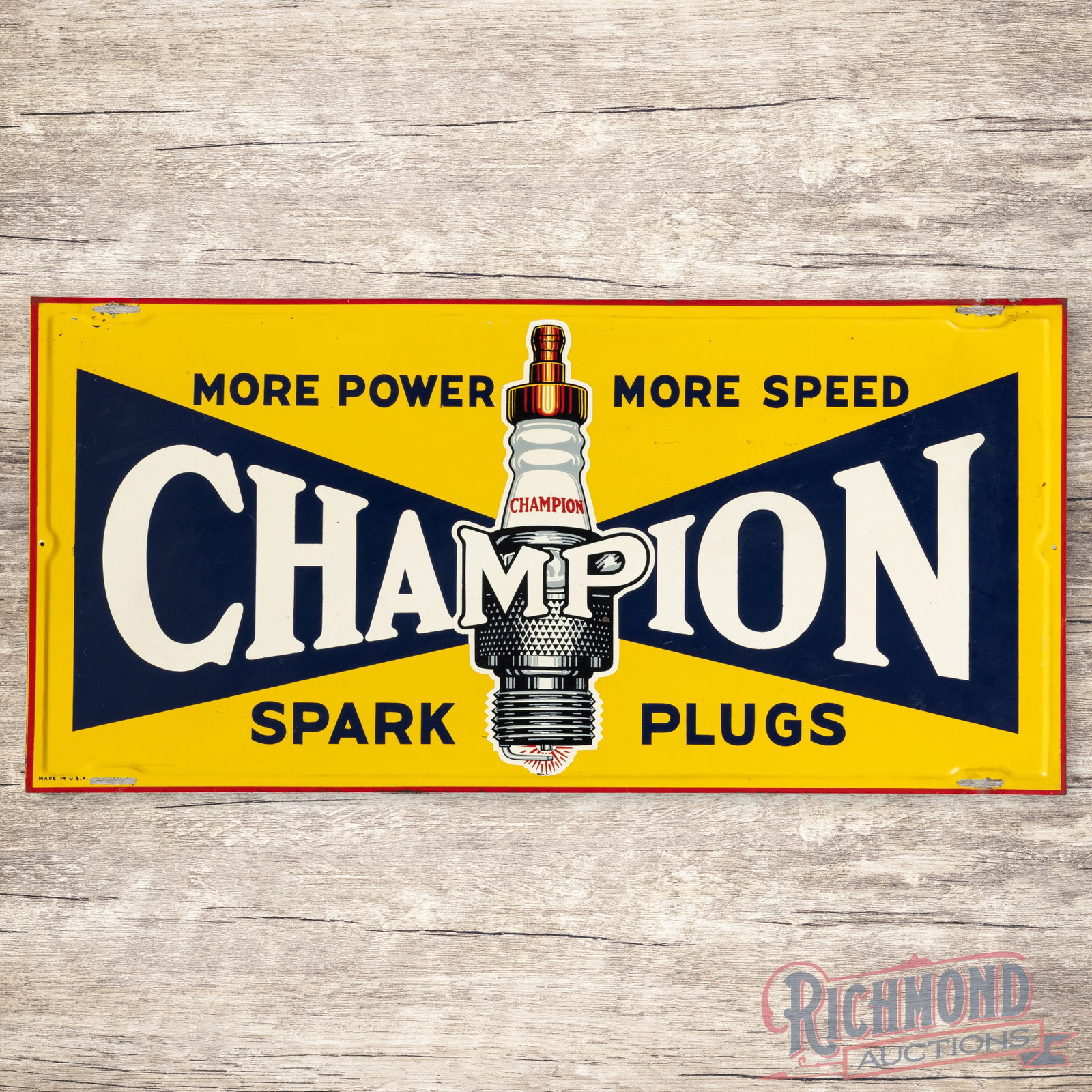 Champion Spark Plugs More Power More Speed Single Sided Tin Sign: SST (single sided tin) self-framed sign has good color and shine. The display has a paint chip in the plug graphic with other light wear and marks in the outer fields. The perimeter has minor bends an