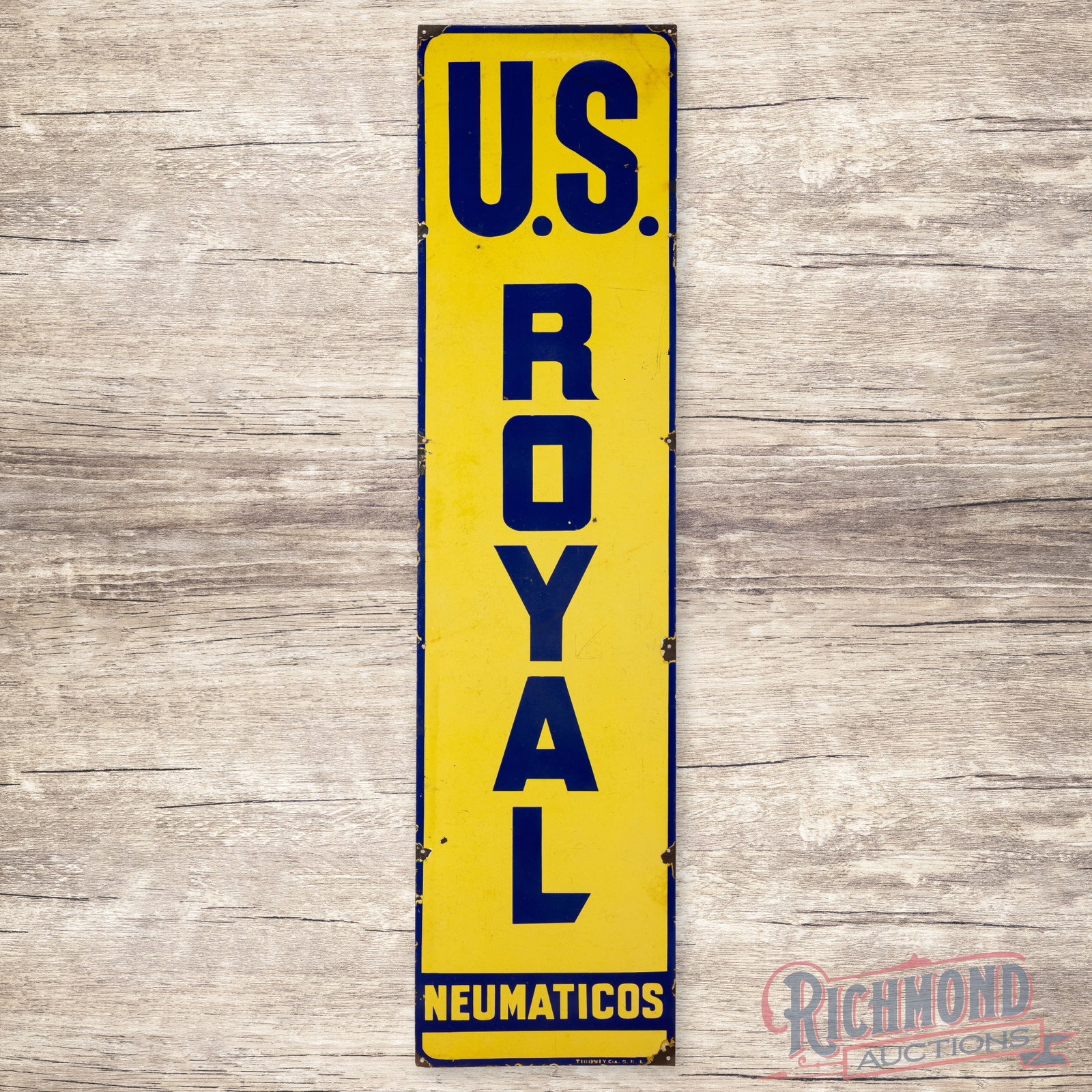 U.S. Royla Neumaticos Single Sided Porcelain Vertical Sign: SSP (single sided porcelain) Vertical Sign has good color. Surface presents with wear throughout, chipping along the mount holes and minor corner dings. Marked Tiboniycasro. 70.75" H X 17.75" W. Condi