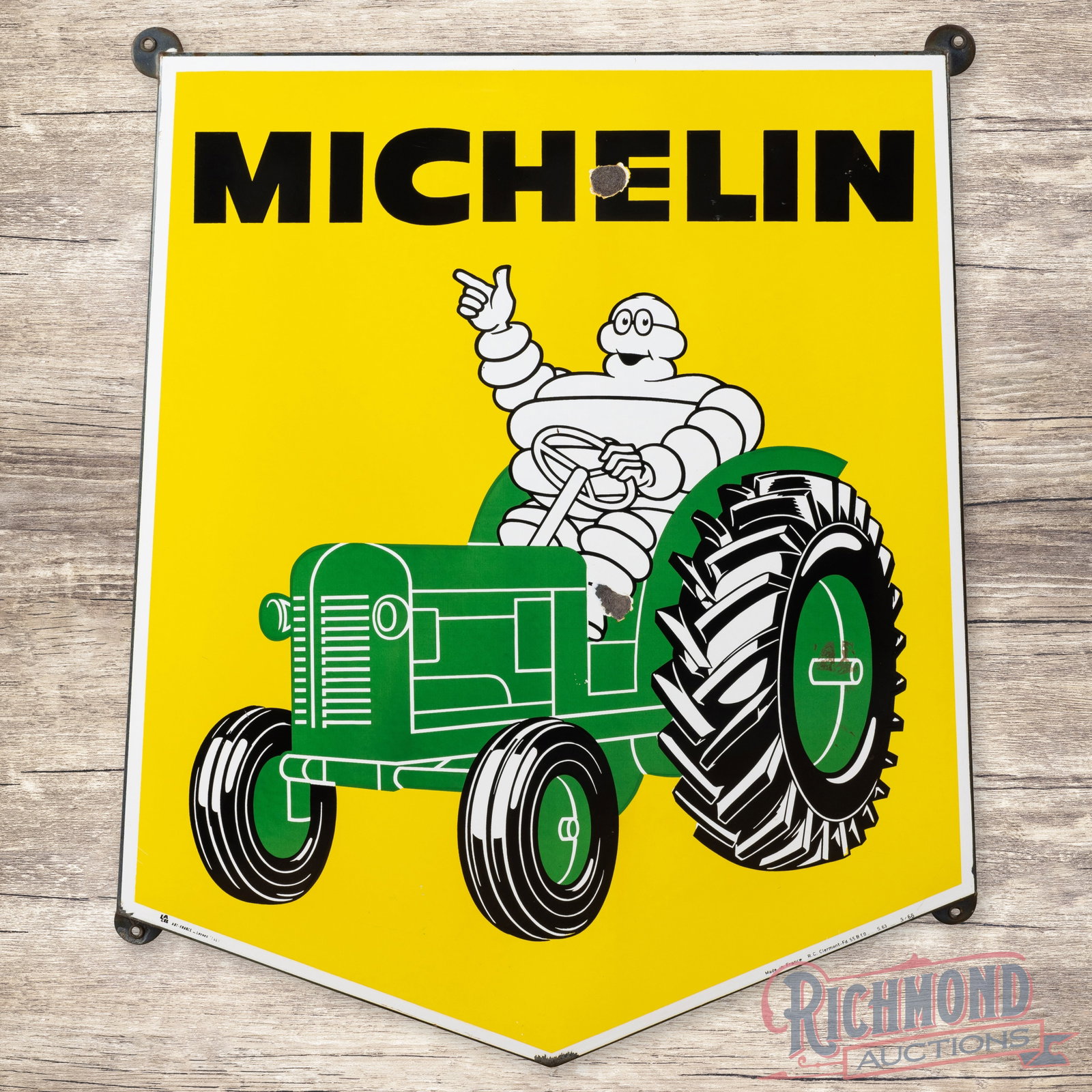 Michelin Tractor Tires Rolled Edge Single Sided Porcelain Sign With Bibendum French: French Michelin Tractor Tires rolled edge sign with tabs. It has excellent color and gloss. It shows some light wear and a few chips. Marked Made In France. Overall it displays very well with a great 