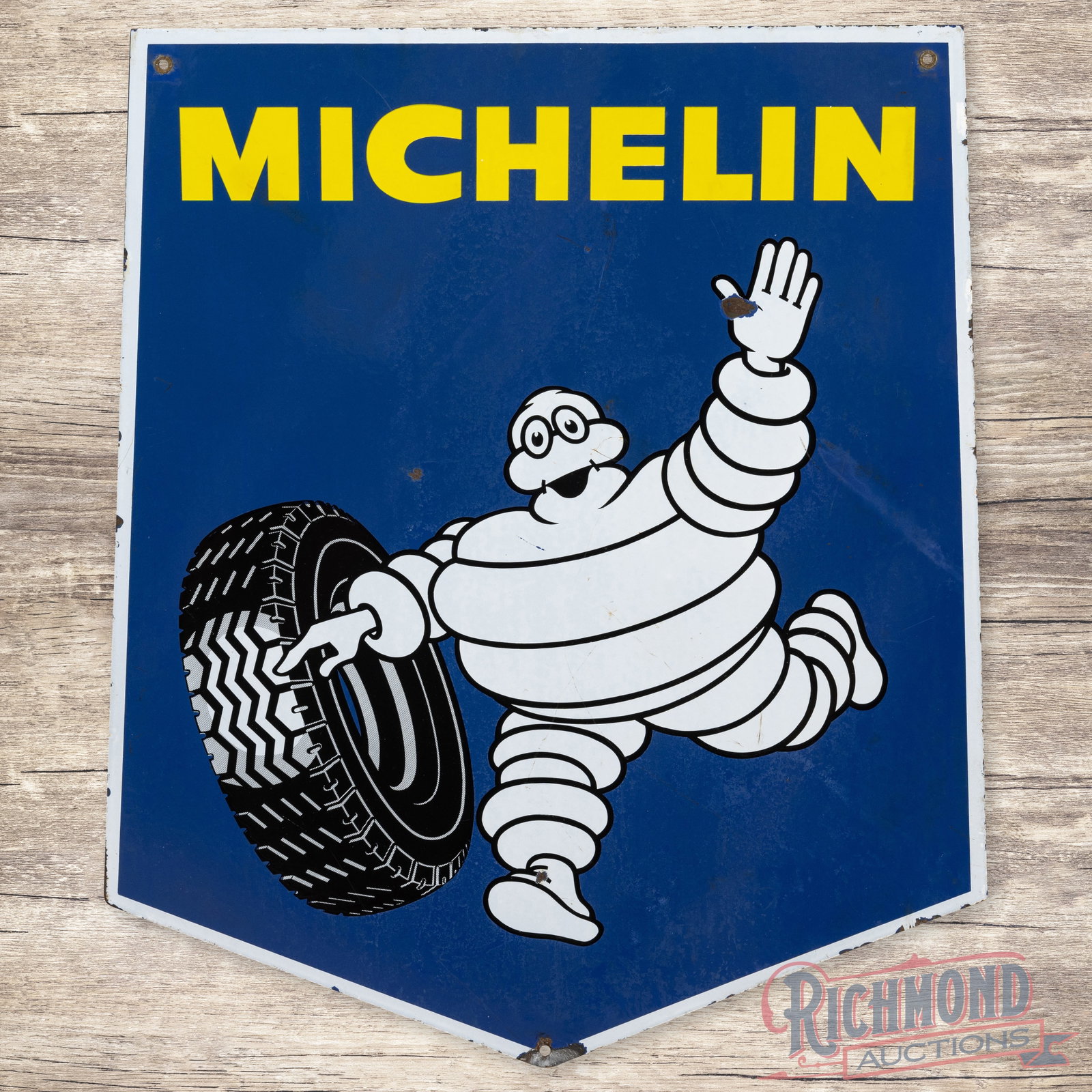 Michelin Tires Double Sided Porcelain Sign French: French Michelin Tires DSP (double sided porcelain) sign. It has good color and gloss. It shows areas of discoloration, wear, a bend at the lower tip, and chipping mainly along the edge. Marked EAS Mad