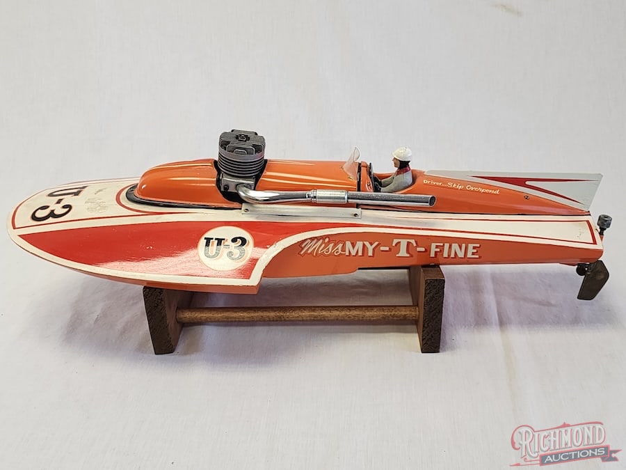Miss My-T-Fine Hydroplane Tether Boat: Beautifully painted and includes driver. Powered by an O.S. engine. 23 inches long. Stand included. All items are guaranteed authentic by Richmond Auctions unless otherwise noted. Purchases are