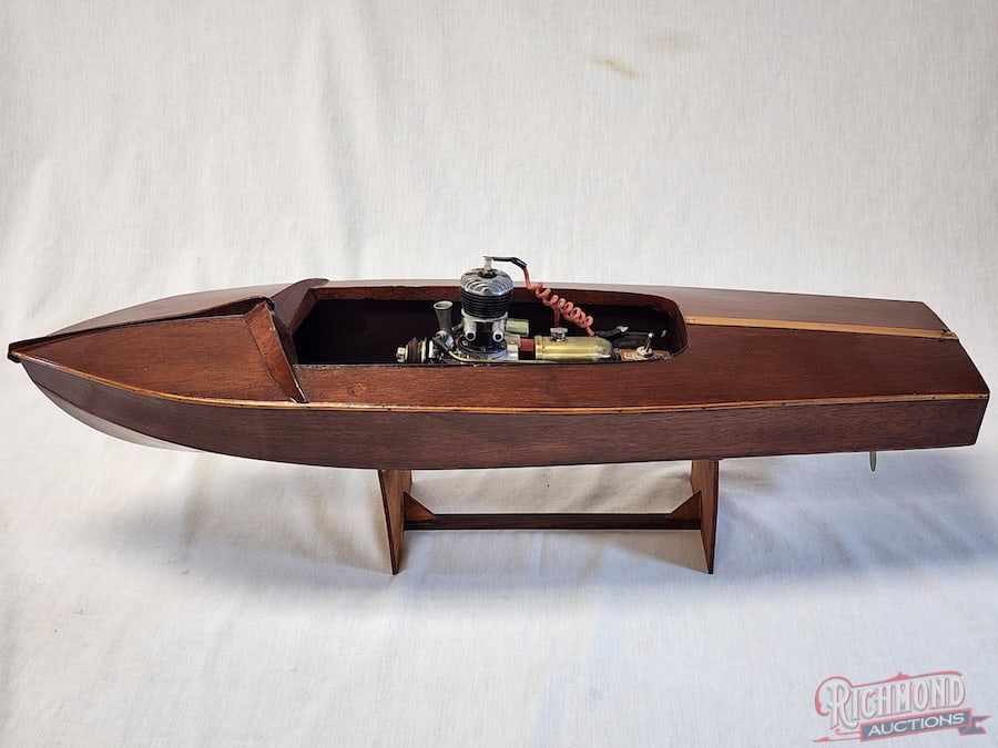 Chris-Craft Wood Hull Tether Boat: Beautifully finished. Powered by a Phantom P-30 engine. 22 inches long. Stand included. All items are guaranteed authentic by Richmond Auctions unless otherwise noted. Purchases are eligible for free