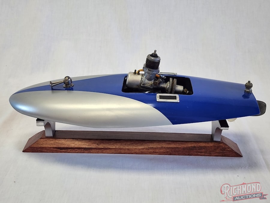 Inboard Tether Boat: Beautifully painted and powered by a .045 Royal Spitfire engine. 13 inches long. Stand included. All items are guaranteed authentic by Richmond Auctions unless otherwise noted. Purchases are eligible