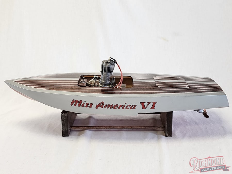 Miss America VI Tether Boat: Beautifully painted and lettered. This Chris-Craft style boat is powered by a Super Cyke .60 engine. 26 inches long. Stand included. All items are guaranteed authentic by Richmond Auctions unless othe