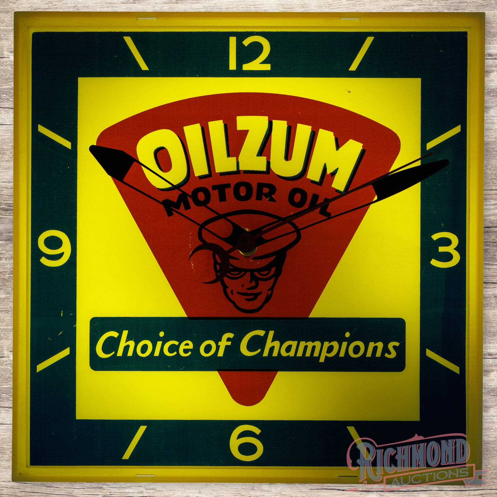 Oilzum Choice of Champions 15" Plastic Lighted Advertising Clock: Plastic internally lighted clock has good color and works properly. The clock features a large Oilzum logo in the field with their famous "Choice of Champions" slogan. The surface has minor wear and t