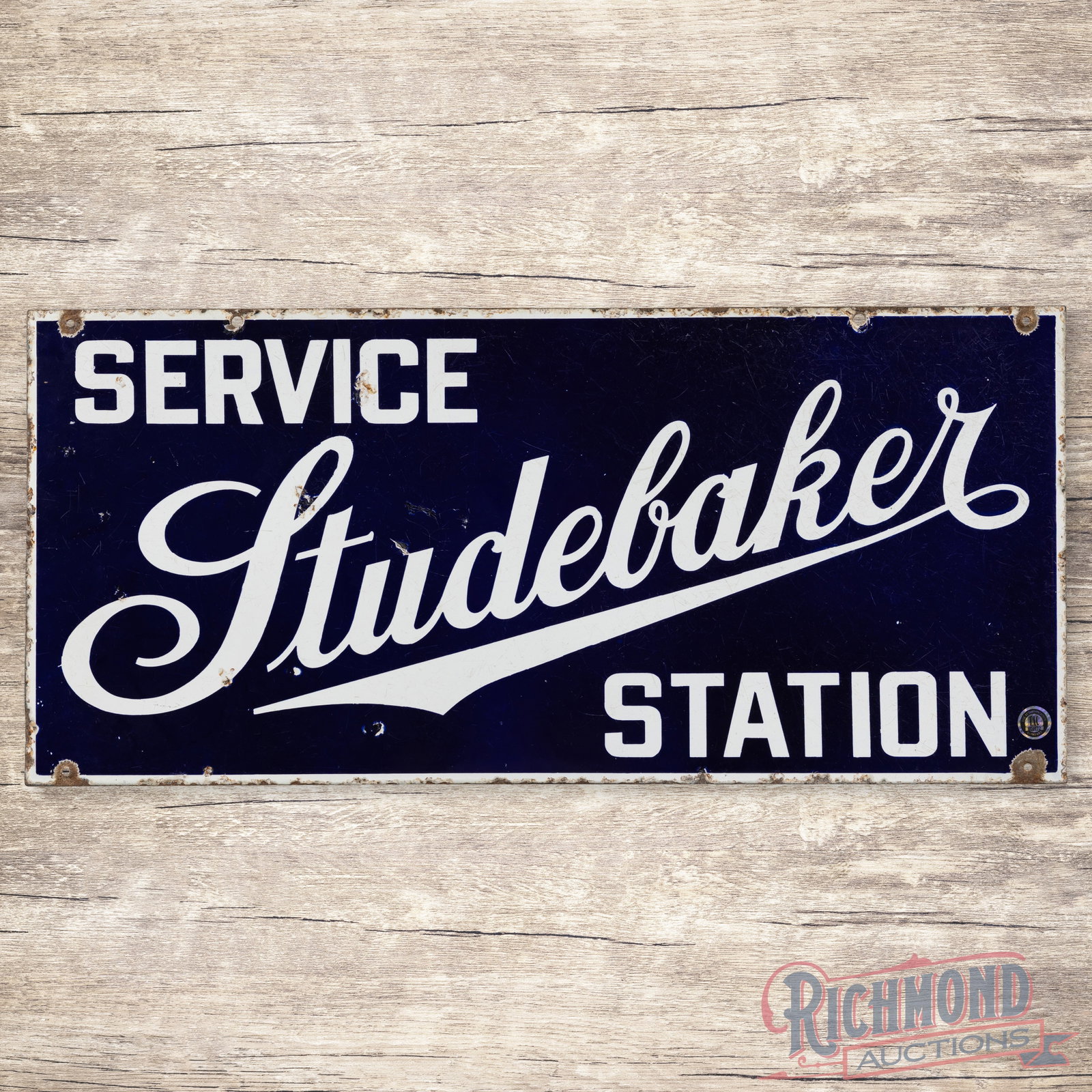 Studebaker Service Station Double Sided Porcelain Sign: DSP (double sided porcelain) sign has good color and gloss. The display has surface wear with chips. The perimeter has edgewear with non-factory holes along the outer corners. The reverse is in a simi
