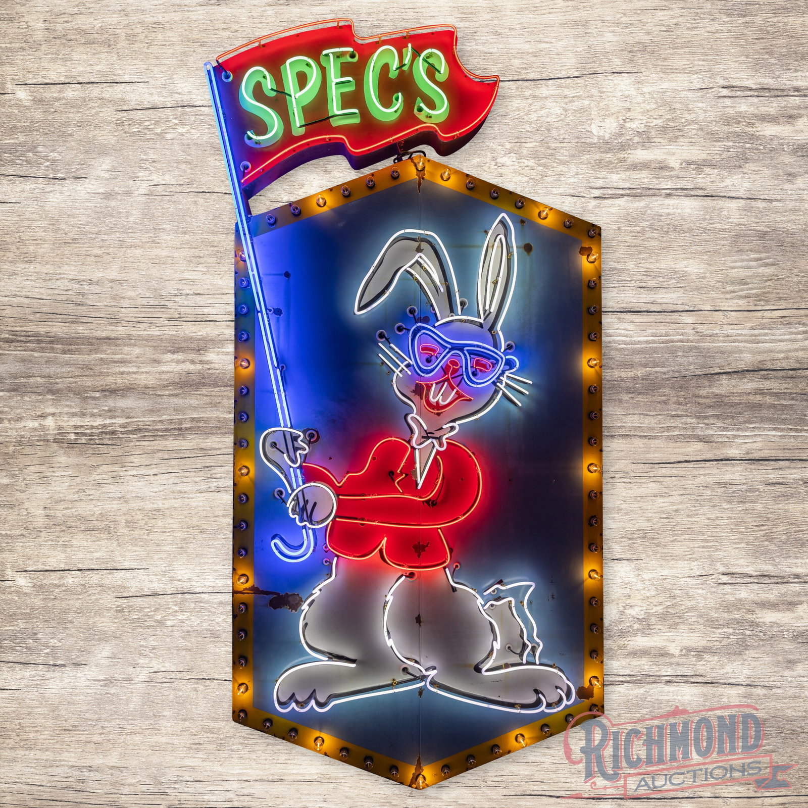 Spec's Liquor 12' Die Cut Porcelain Factory Neon Rabbit Sign w/ Lighted Chaser Bulbs & Flag: SSP (single sided porcelain) factory neon sign with perimeter chaser bulbs and a metal can has good color. The sign has outstanding graphics of the "Spec's" Rabbit with glasses holding a "Spec's" flag