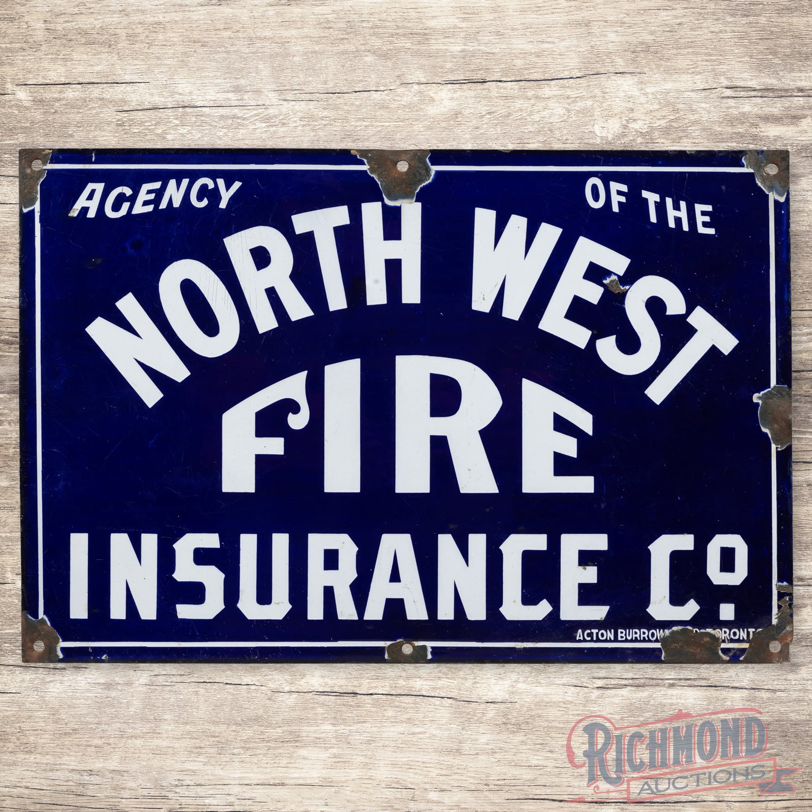 North West Fire Insurance Co. Single Sided Porcelain Sign: SSP (single sided porcelain) sign has very good color and gloss. The field have surface wear with fine scratches and a small chip beside the "E" in West. The perimeter has chips at the mounting holes 