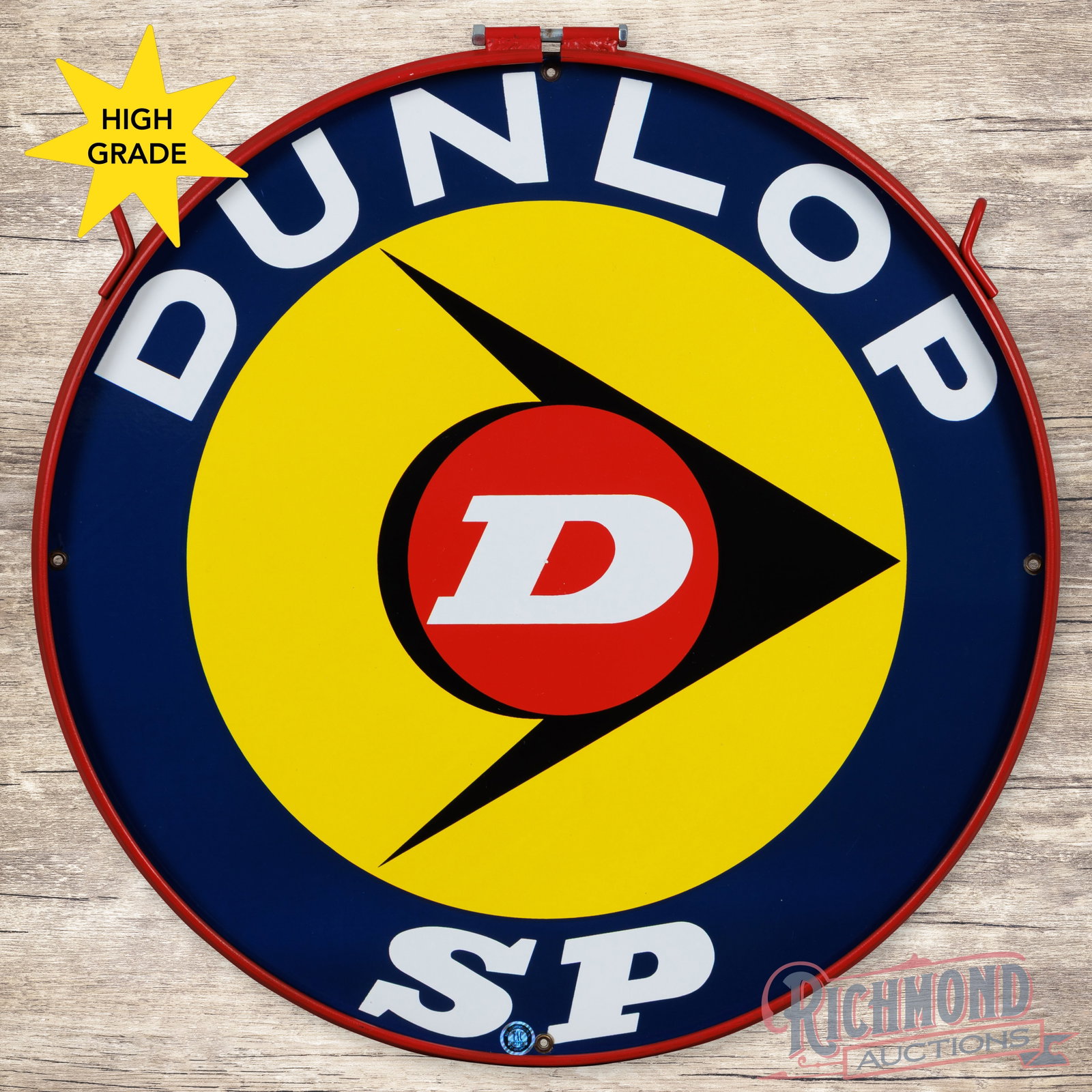 Dunlop SP Tires 27" Double Sided Porcelain Sign w/ Ring: DSP (double sided porcelain) sign with an added metal ring has excellent color and gloss. The display has a clean field and perimeter. The reverse has minor wear at the mounting holes and edges. The m