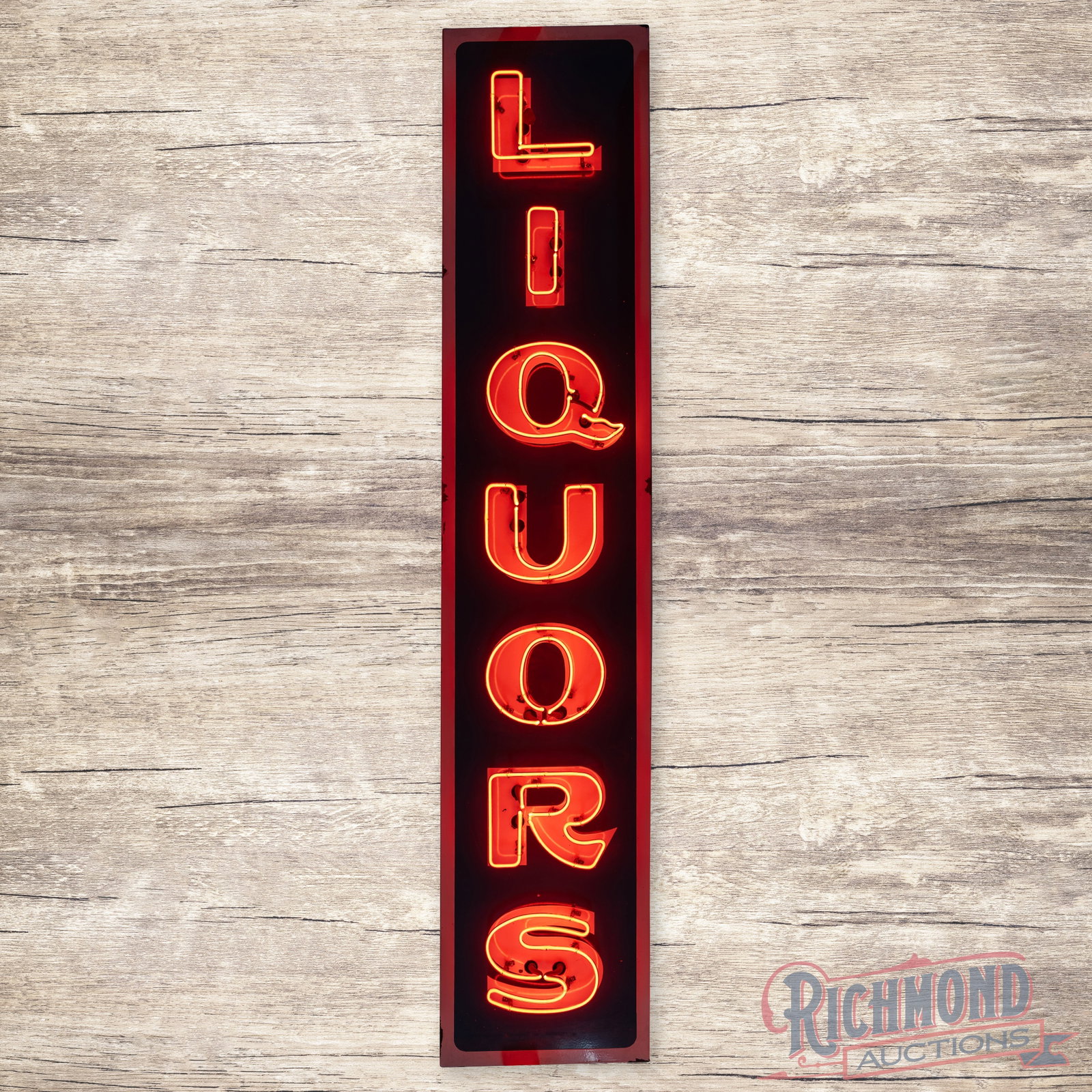 Liquors 9' Single Sided Porcelain Factory Neon Sign: SSP (single sided porcelain) factory neon sign with a metal can has excellent color and gloss. The display has light wear with minor discoloration and chips in the lettering. The perimeter has chips a