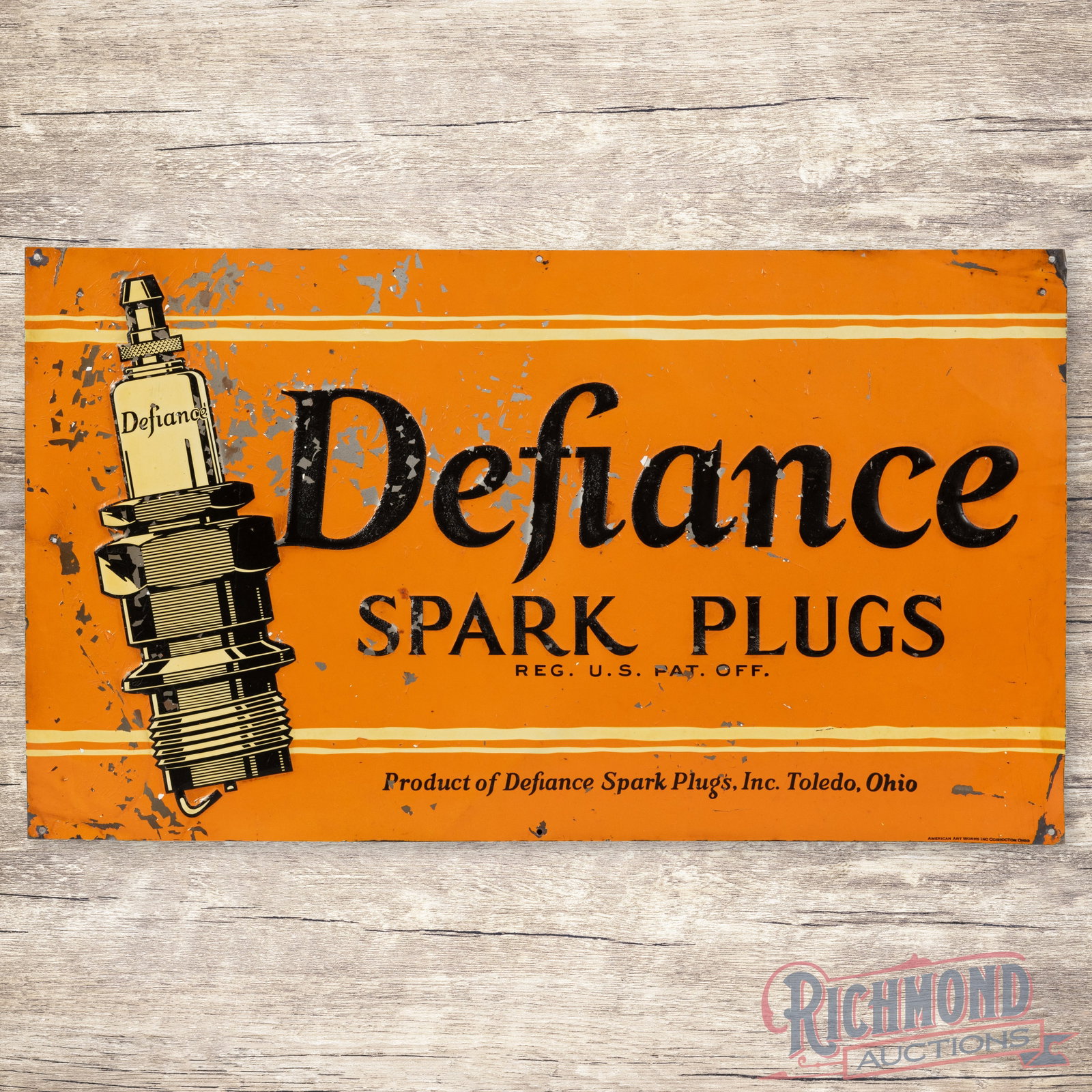 Defiance Spark Plugs Emb. Single Sided Tin Sign: SST (single sided tin) embossed sign has very good color and shine. The sign has an added clear coat to enhance the finish. The display has light wear with paint chips. The outer fields and perimeter 