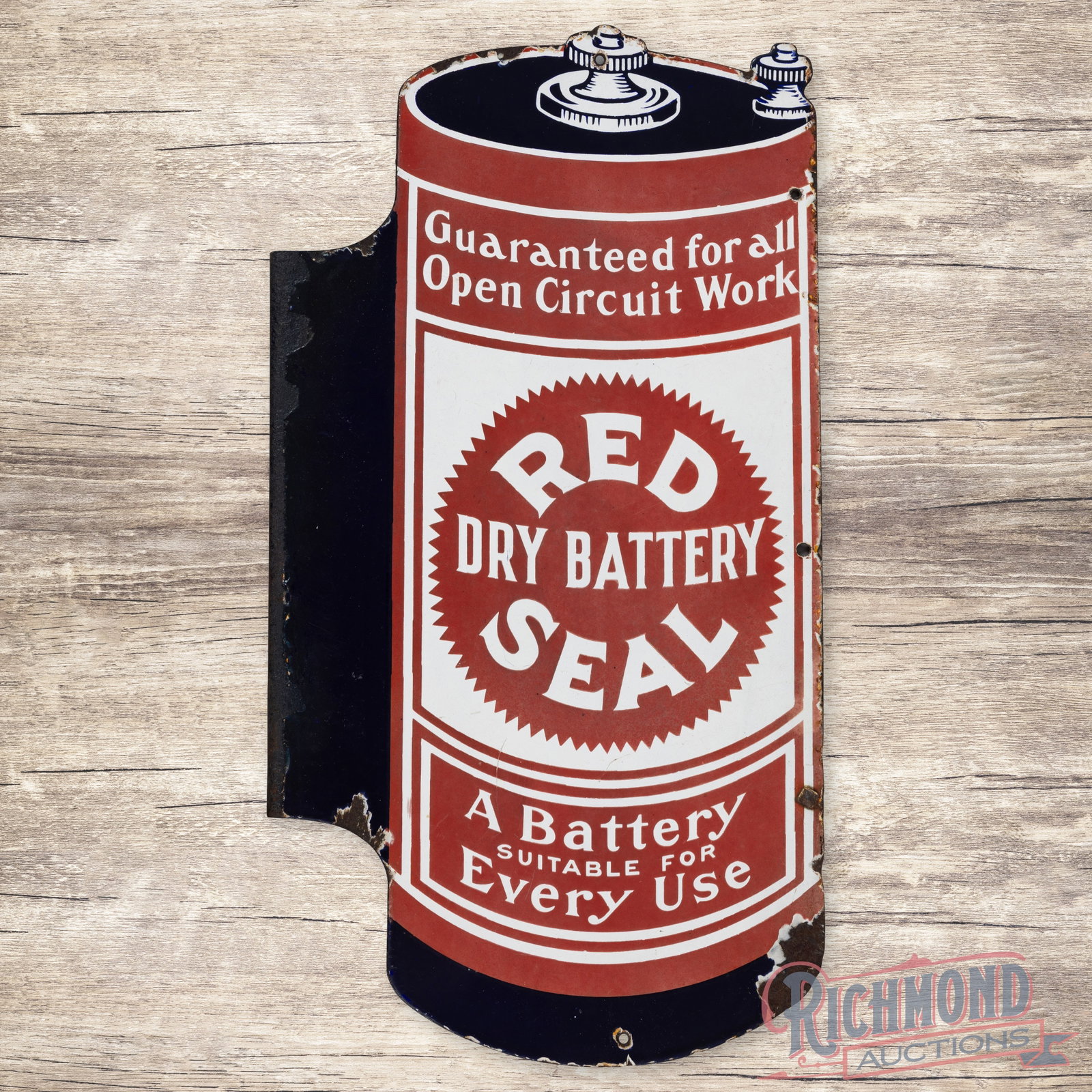 Red Seal Dry Battery Die Cut Double Sided Porcelain Flange Sign: DSP (double sided porcelain) die cut flange has good color and moderate gloss. The display has surface wear with slight fading throughout. The perimeter has added mounting holes, chips and edge wear. 