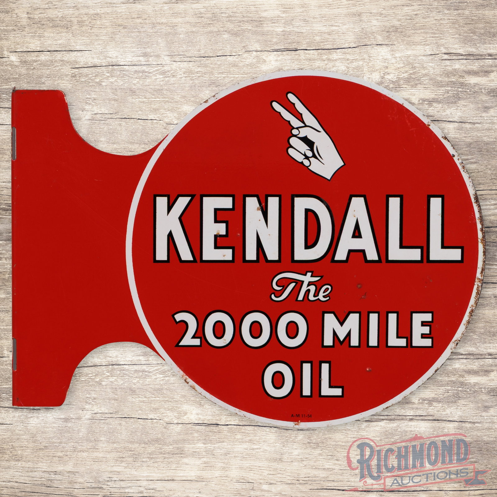 1954 Kendall The 2000 Mile Oil Double Sided Tin Flange Sign: DST (double sided tin) die cut flange has very good color and shine. The display has light wear with scuffs and fine scratches in the fields. The perimeter has paint chips along the outer edges. The r