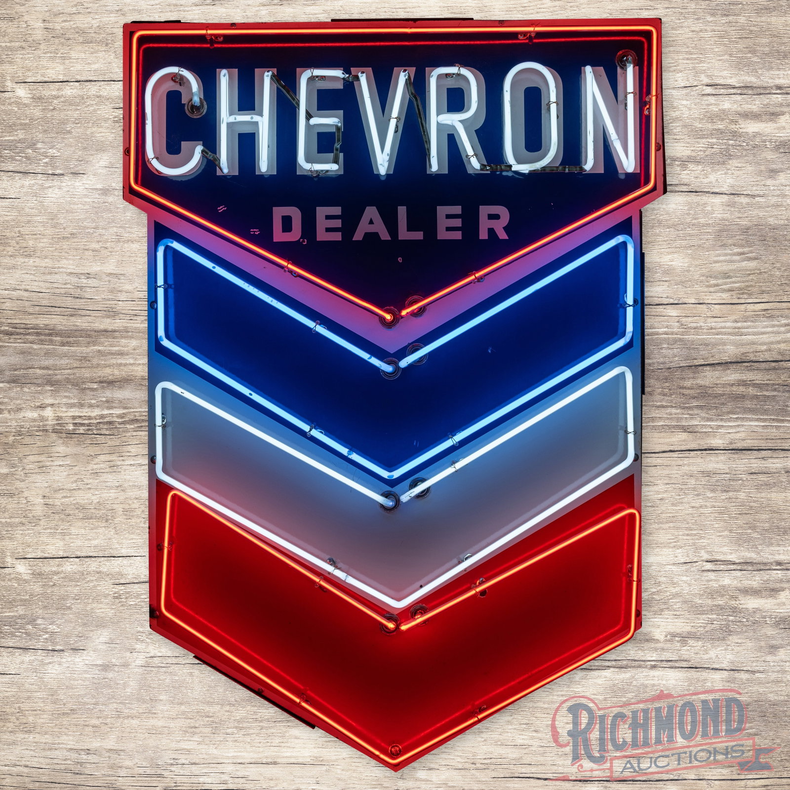 Chevron Gasoline Dealer 4.5' Single Sided Porcelain Neon Sign w/ Hallmark: SSP (single sided porcelain) die cut sign has excellent color and gloss. The sign features brilliant two-color neon. The display has small chips with added unused stand support holes. The perimeter ha