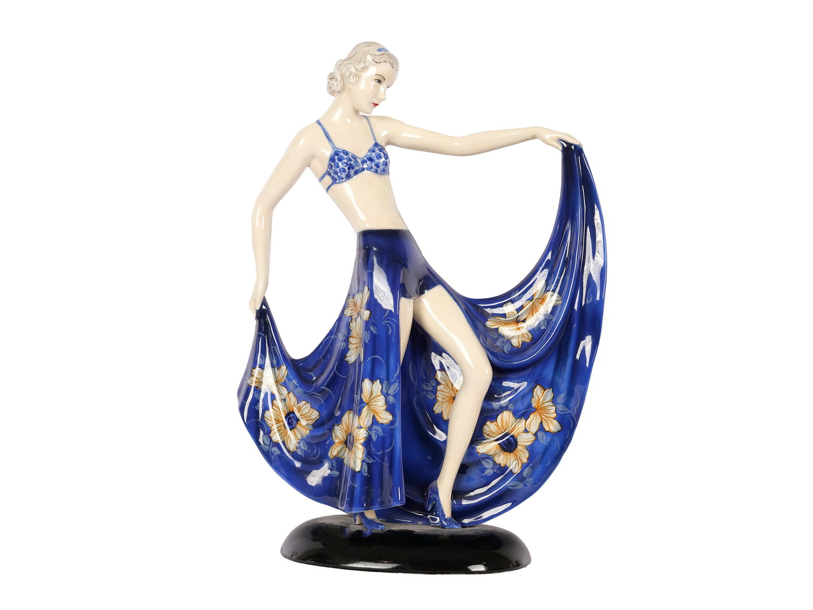 Goldscheider Vienna c. 1920/25, Dancer in a blue skirt: Goldscheider Vienna c. 1920/25 Dancer in a blue skirt designed by Stefan Dakon Ceramic, white body, colourfully painted, glazed Height 38.5 cm, width 27 cm Artist's signature Dakon on the base Marked