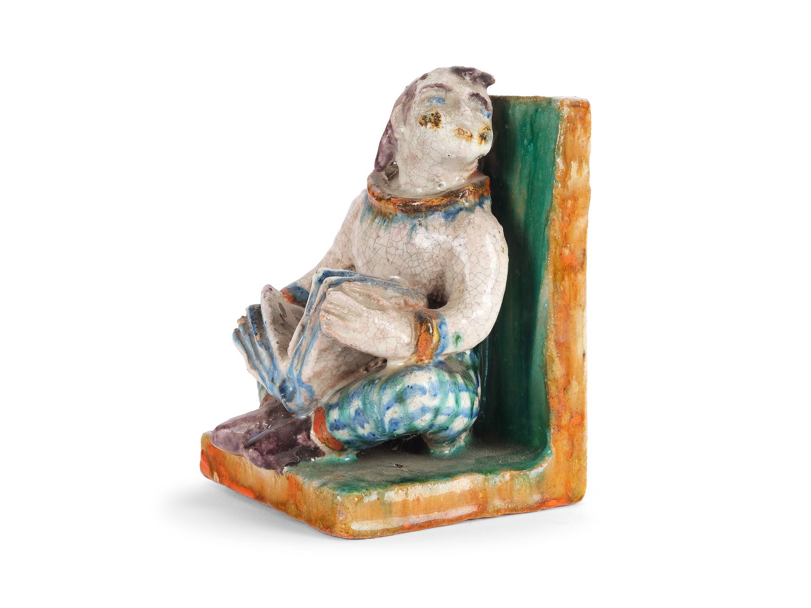 BOOKEND, IN THE STYLE OF THE ARTISTS OF THE WIENER WERKSTAETTE: BookendIn the style of the artists of the Wiener Werkstaette1920Red glazed shards and colorful decorationHeight 13 cmMinimal damage to the base