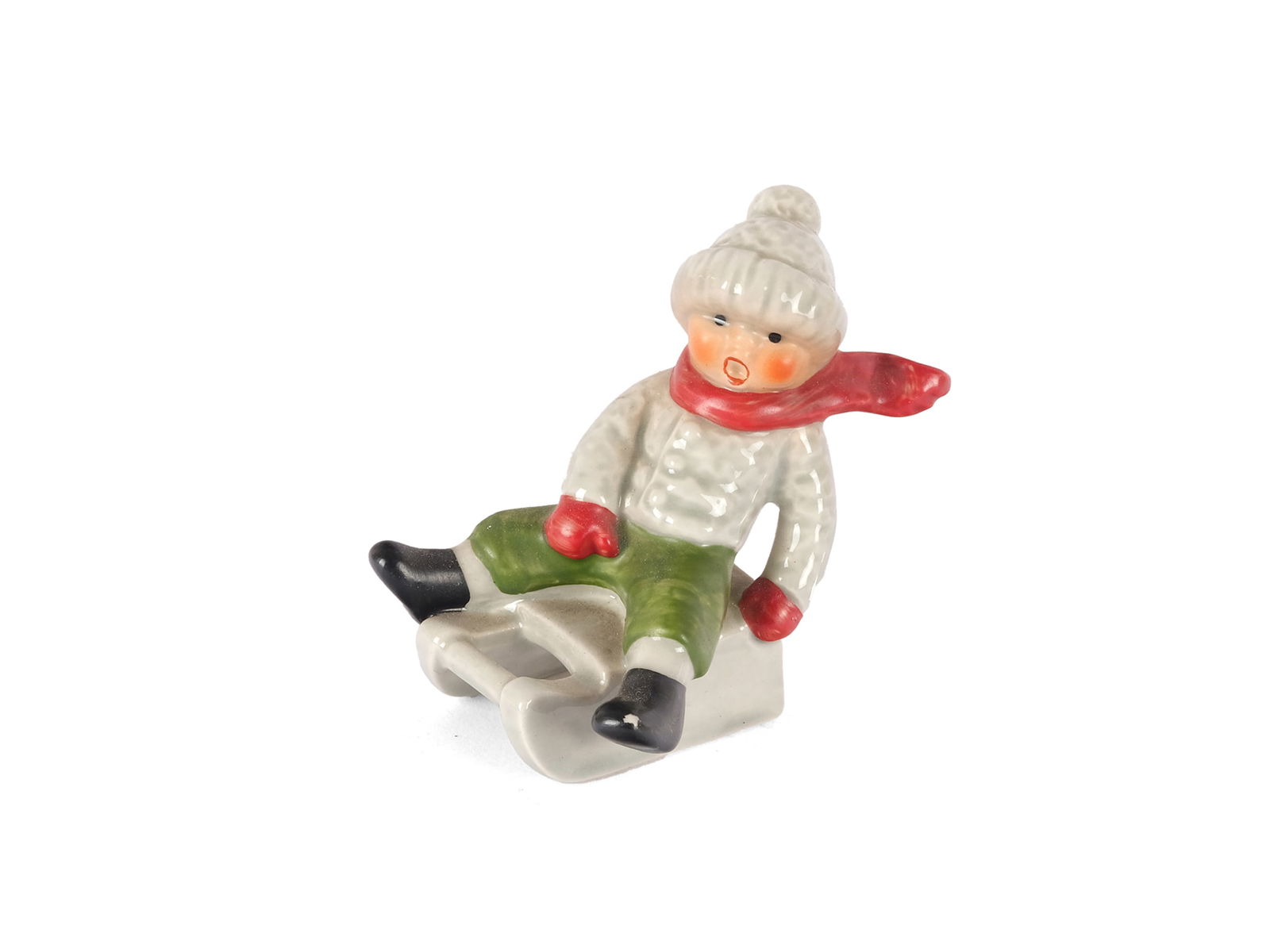 KARL GOEBEL, WESTERN GERMANY: Karl GoebelWestern Germany1950s/60sThe Little TobogganerCeramic, colorfully paintedMarked on the bottomHeight 7 cmOnline viewing only!