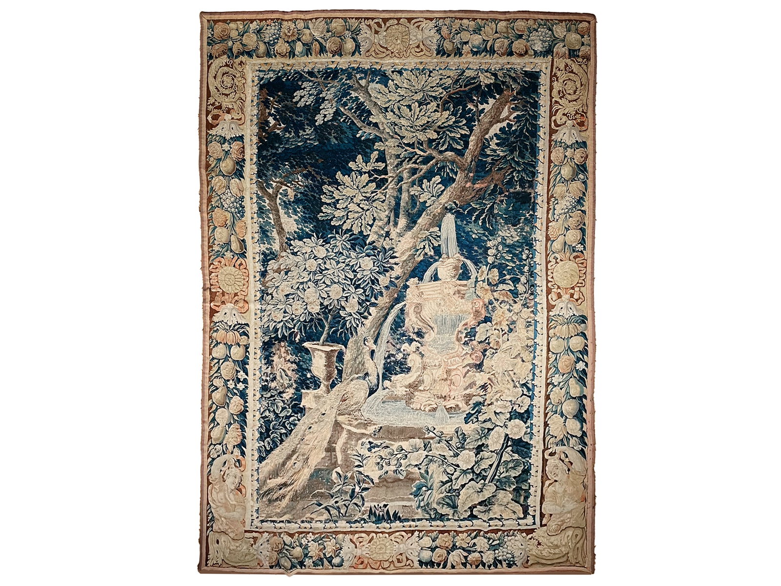 PEACOCK AT A FOUNTAIN, WALL TAPESTRY: Peacock at a FountainWall TapestryFranceCirca 1700Fine wool and silk weavingApprox. 205 x 282 cmOld repairs and with added outer braid, fully mounted on fabric