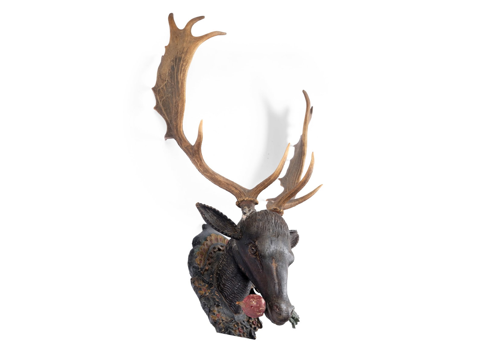 DEER HEAD WITH RADISHES, 18TH CENTURY: Deer head with radishes18th centuryWood carved and polychromed83 x 54 cm