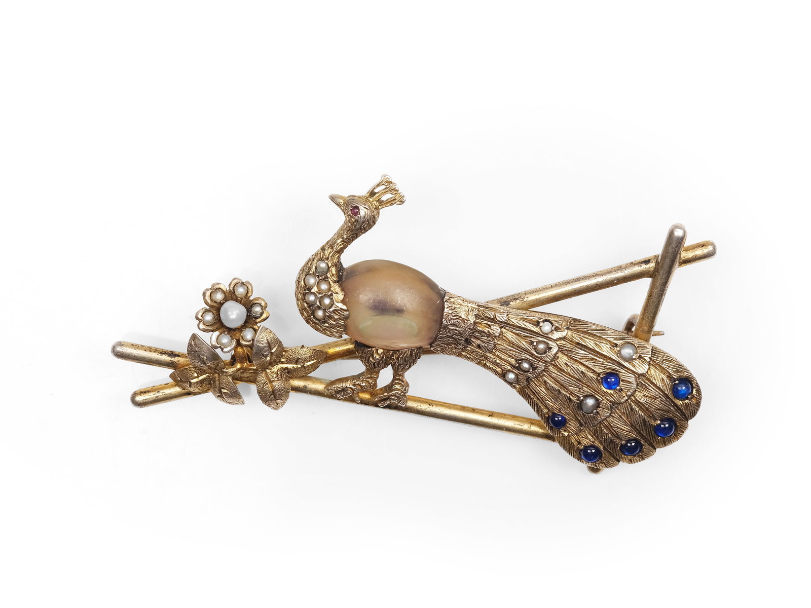 PEACOCK BROOCH, GILT SILVER: Peacock broochGilt silver1920s, with pearls and blue glass stonesLength 4.5 cmWeight 15.8 g