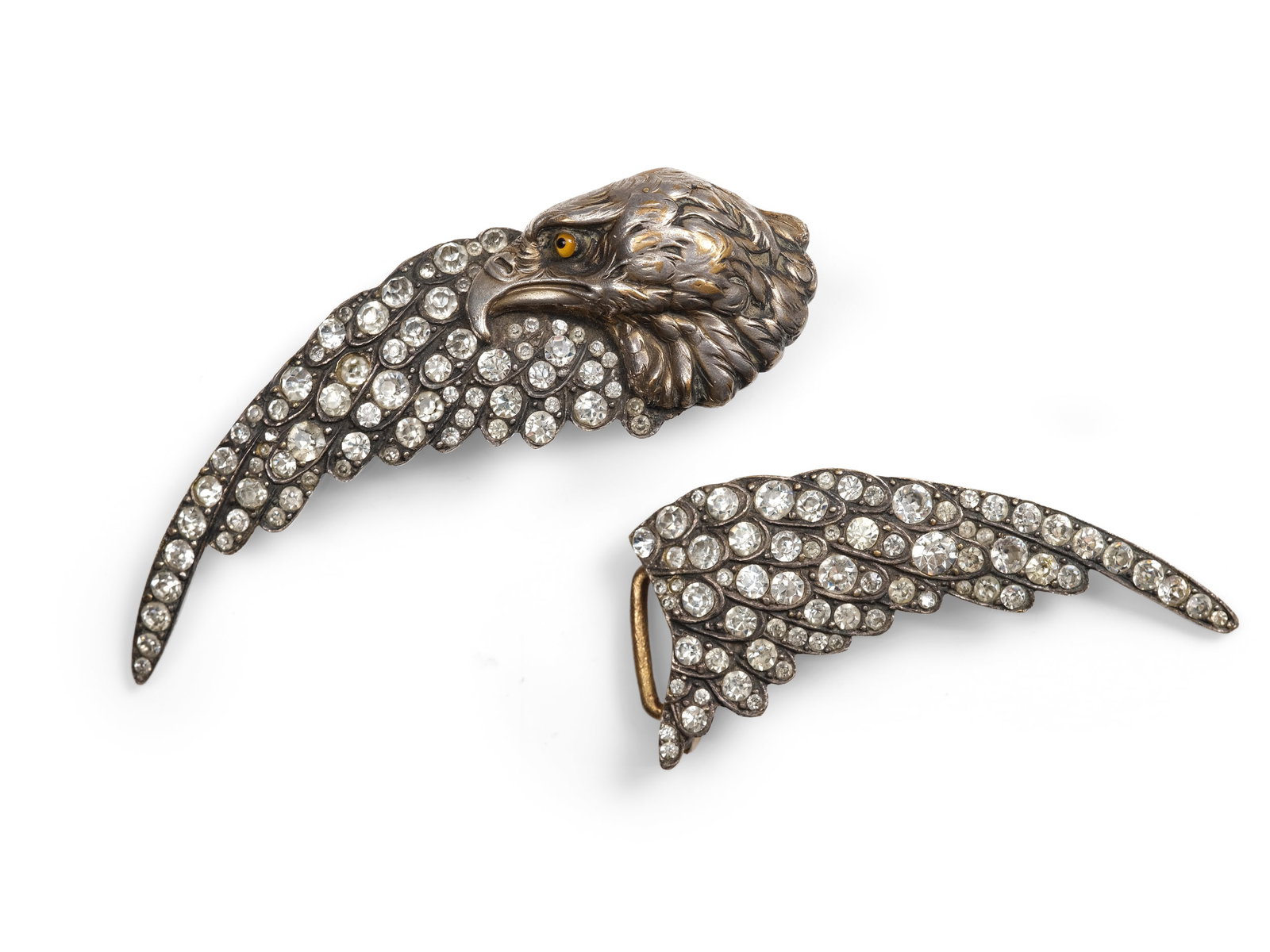 BELT BUCKLE IN THE SHAPE OF AN EAGLE, CIRCA 1900/20: Belt buckle in the shape of an eagleCirca 1900/20Silver-plated metalDecorated with glass eyes and rhinestones Length 14.5 cmWeight 82 g