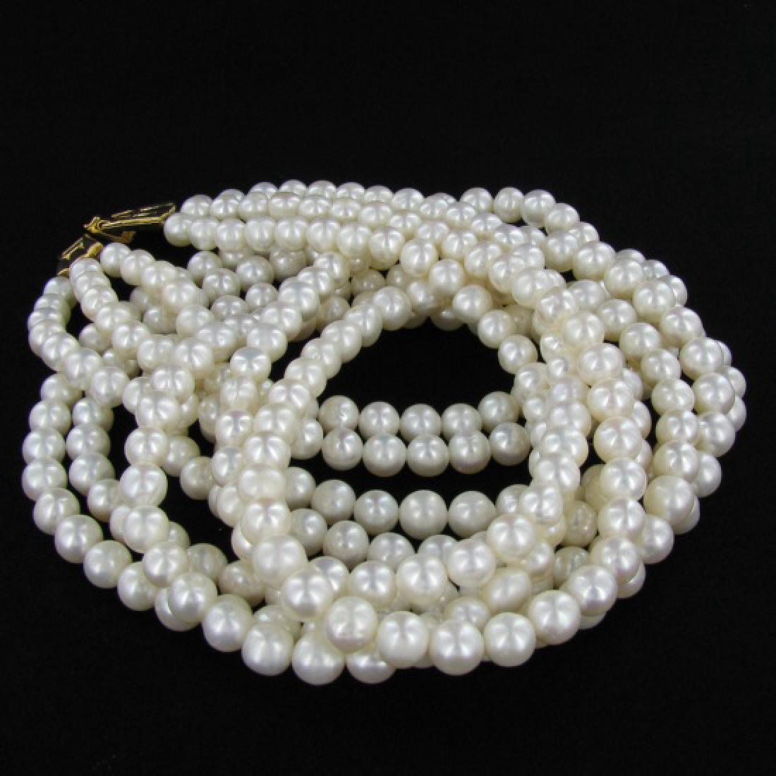 White Saltwater Pearl Three Strand Necklace: Excellent white saltwater pearls; uniformly sized (6.5mm); 330 count; 75" (25" 3 strands);