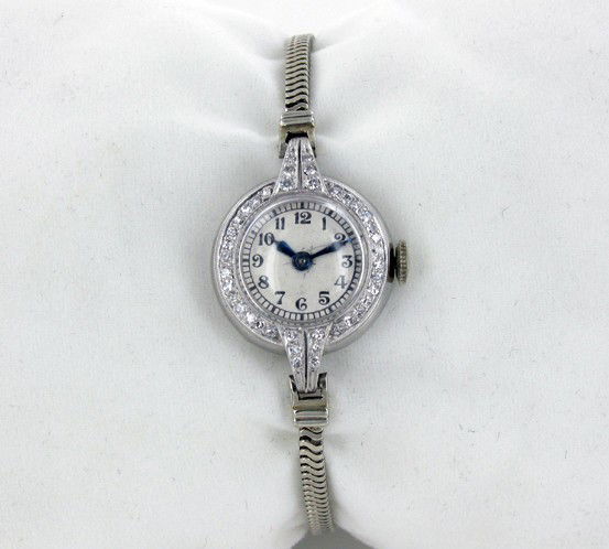 Ladies Platinum/White Gold & Diamond Movado Watch: RARE 1950s; Well running in great condition; Caliber 50SP movement; 40 clean white diamonds set around the face; platinum & gold value alone over $400