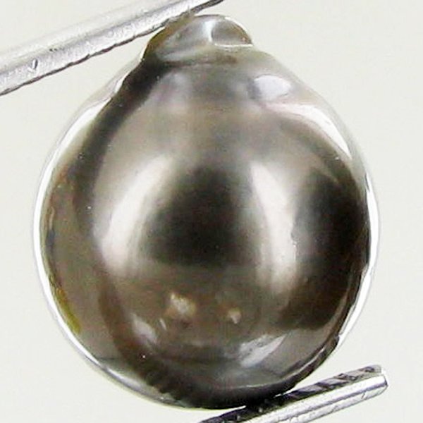 9.9ct Freeform Tahitian Black Pearl: Scarcely shaped; drilled and ready for one-of-a-kind pendant