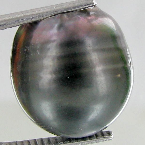20.72ct Freeform Tahitian Black Pearl: Scarcely shaped; drilled and ready for one-of-a-kind pendant