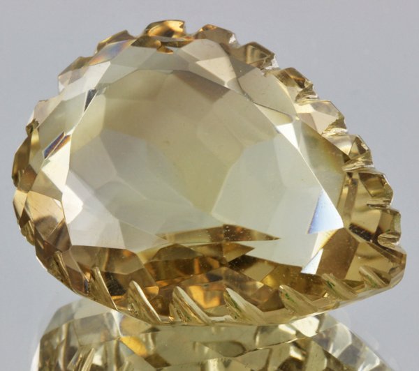 65ct Lemon Yellow Citrine Carved Cut: Excellent heated grade 9 of 10 specimen; estimated Gem Guide wholesale $35, estimated retail $100; Brazil origin