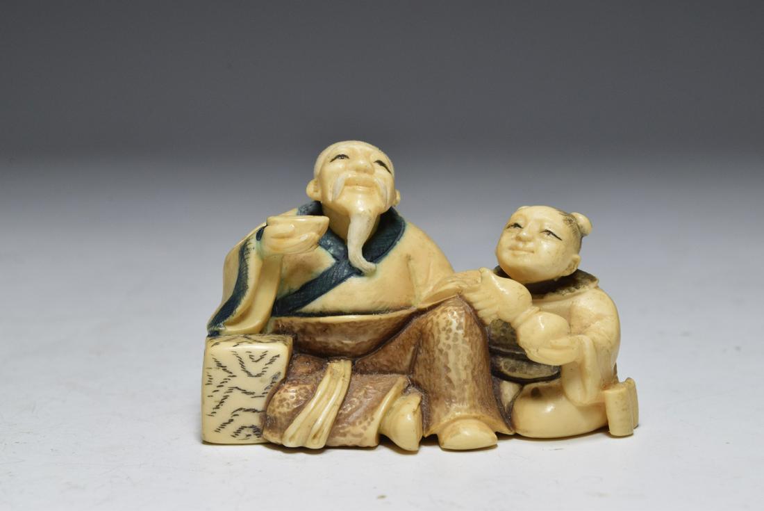 Japanese White Bone Old Man with Child Netsuke: Japanese White Bone Old Man with Child Netsuke (1.5 x 1.9 x 1 inches)