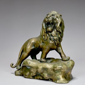 Bronze Sculpture Of Lion Standing On A Rocky Mound