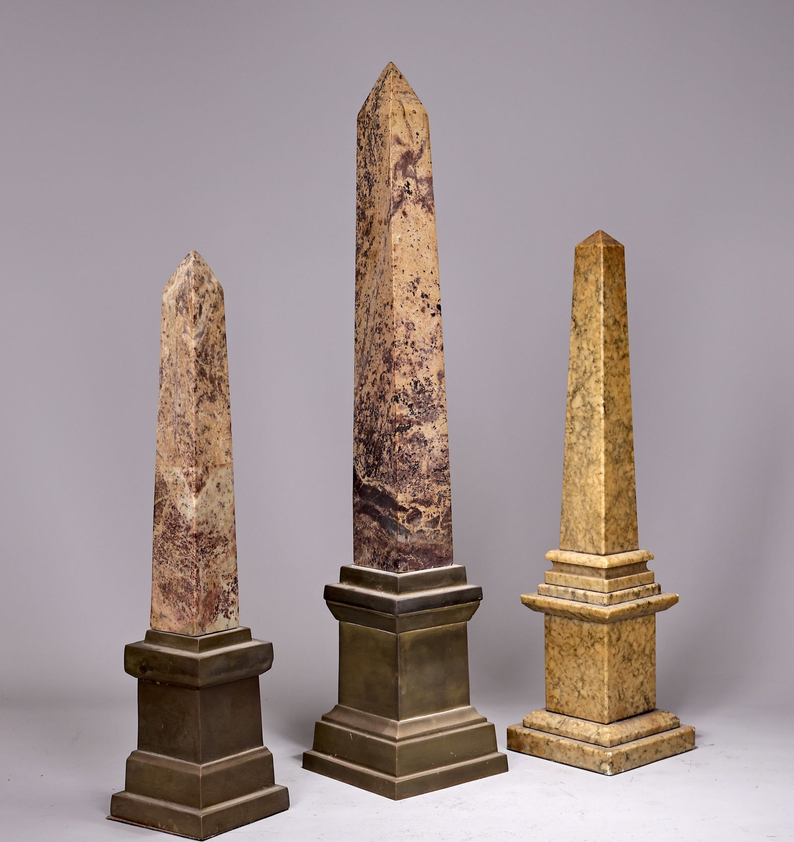 Group Of Three Obelisks In Different Marbles Brass Base: Group Of Three Obelisks In Different Marbles Brass Base (60 x 12 x 12 cm, 44.5 x 10 x 10 cm each)