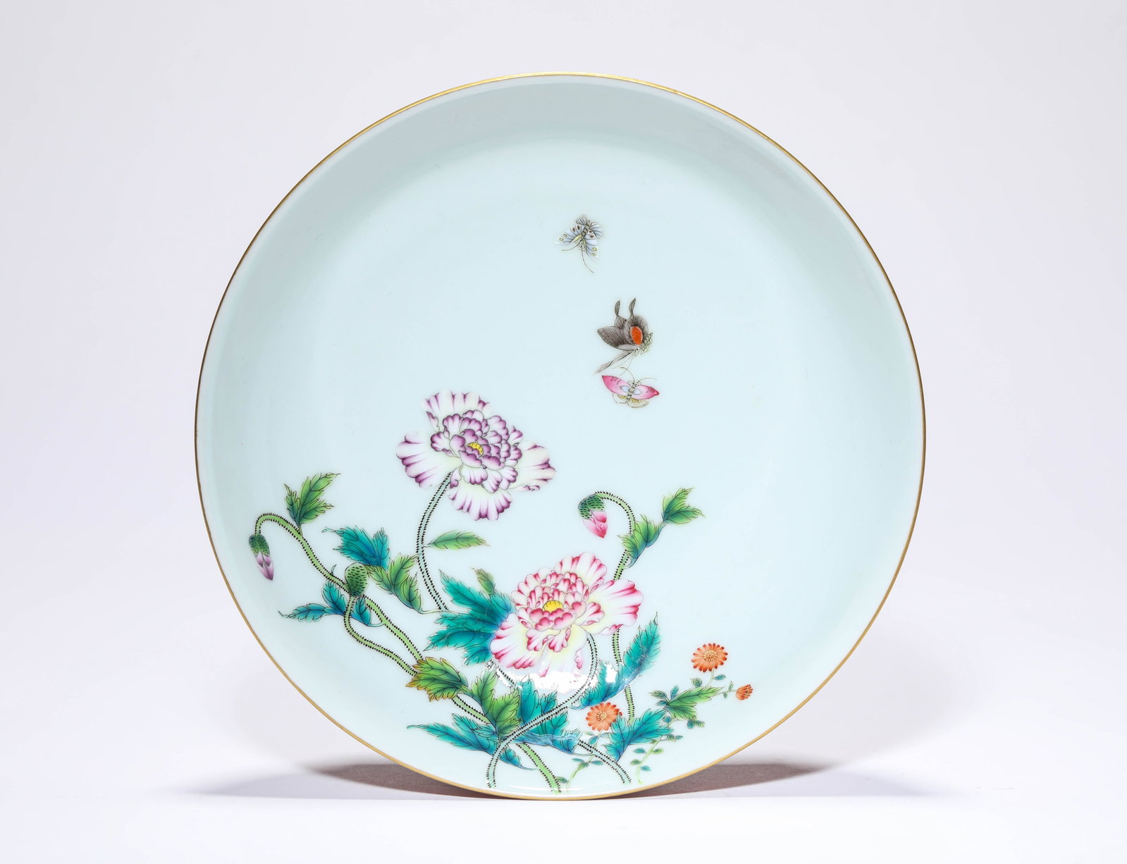 A CORAL-RED-GROUND FAMILLE-ROSE ‘BUTTERFLIES AMONG FLOWERS’ DISH (1 of 4)