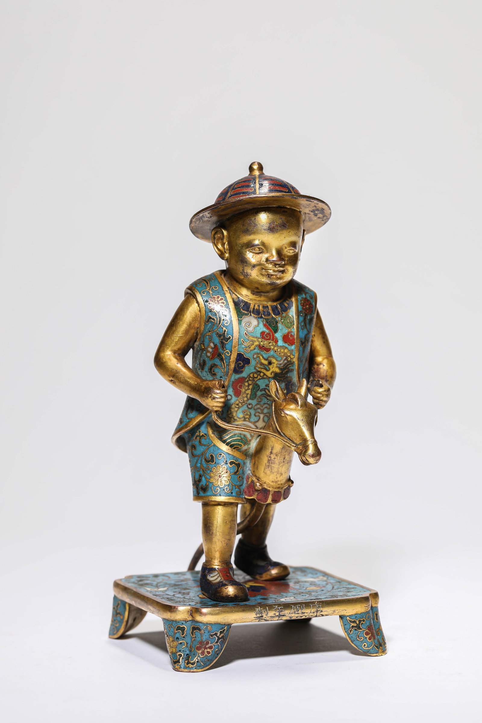 A CLOISONNé ENAMEL FIGURE: A CLOISONNé ENAMEL FIGURE A CLOISONNé ENAMEL FIGURE Description: Dimensions: Weight: 577 g. Length: 8.2 cm x Width: 10.7 cm x Height: 18 cm. All measurements are approximate.