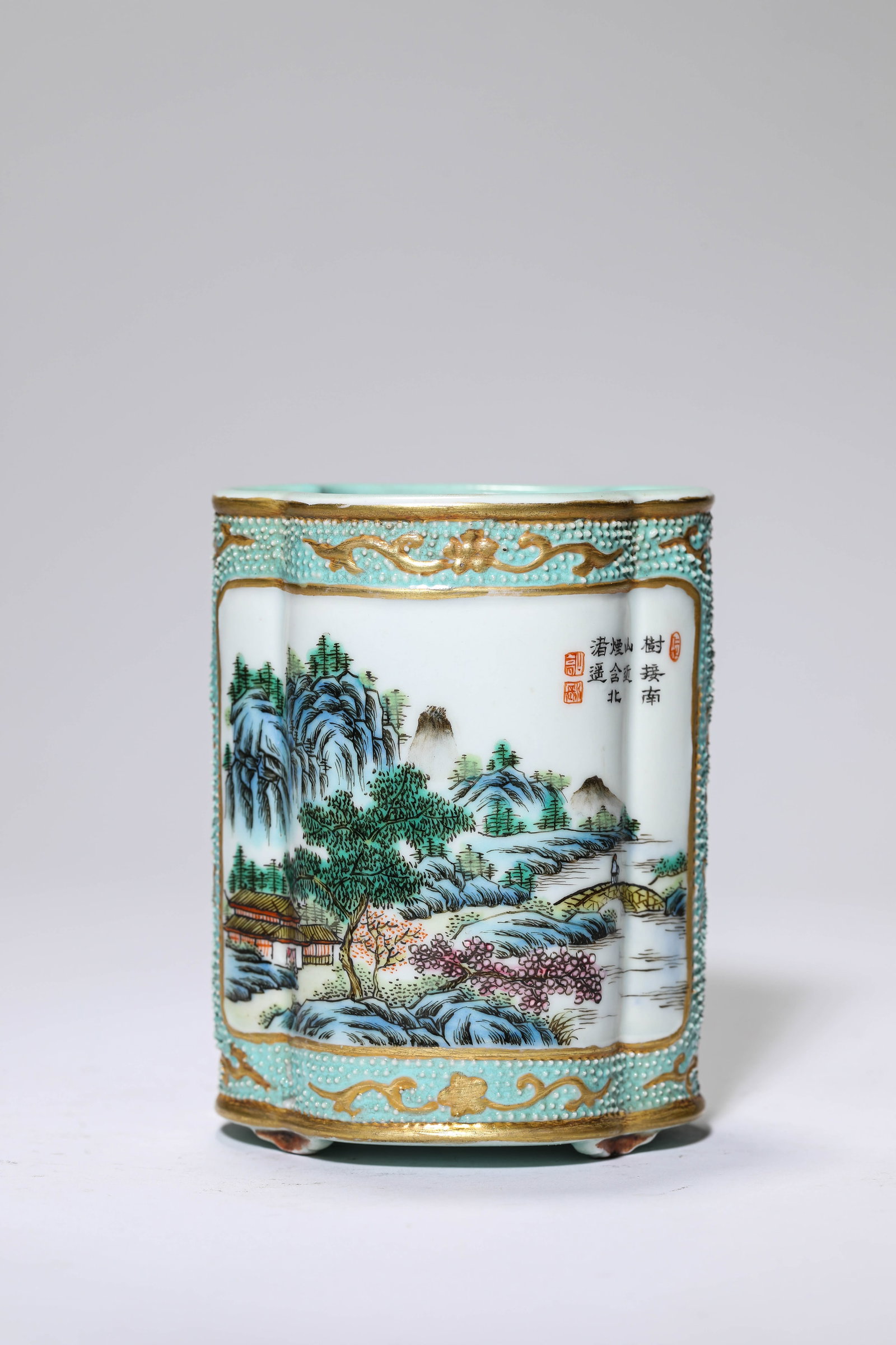 A Bean-Green-Ground Famille-Rose ‘Landscape and Figures Reserves’ ‘: A Bean-Green-Ground Famille-Rose ‘Landscape and Figures Reserves’ ‘Crabapple-Form’ Brush Pot Dimensions: Length: 7.7 cm x Width: 7 cm x Height: 10 cm. All measurements are