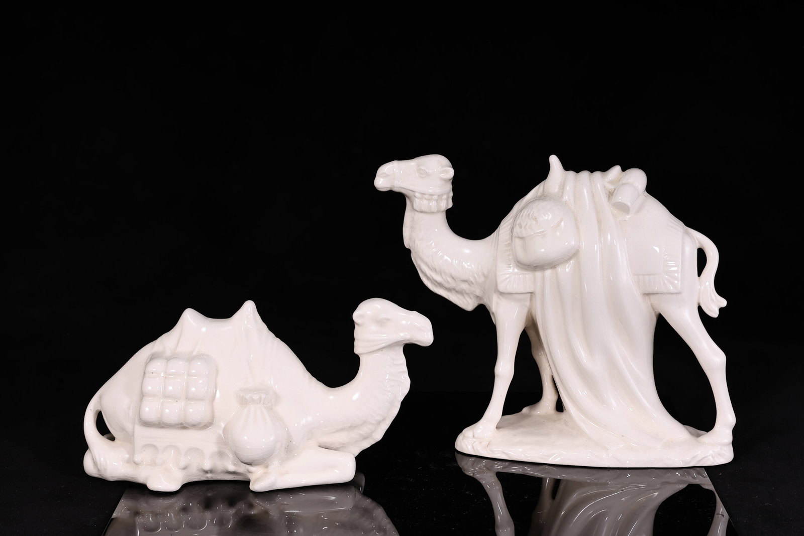 Pair of White Glazed Porcelain Camel Figurines: Pair of White Glazed Porcelain Camel Figurines (24 x 14 x 12 cm, 27 x 21.5 x 12 cm)