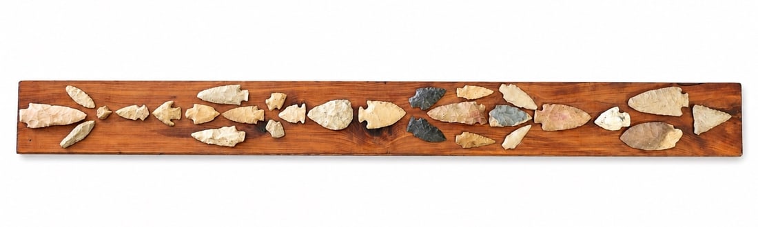 Native American Arrowheads On Wooden Display Board.: Native American Arrowheads On Wooden Display Board. (102 x 8.5 x 1 cm)