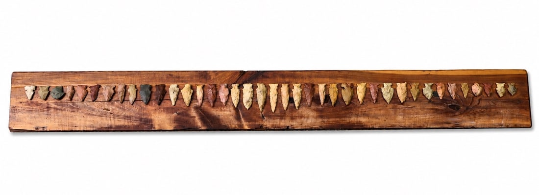 Native American Arrowheads On Wooden Display Board.: Native American Arrowheads On Wooden Display Board. (78 x 8.5 x 0.5 cm)