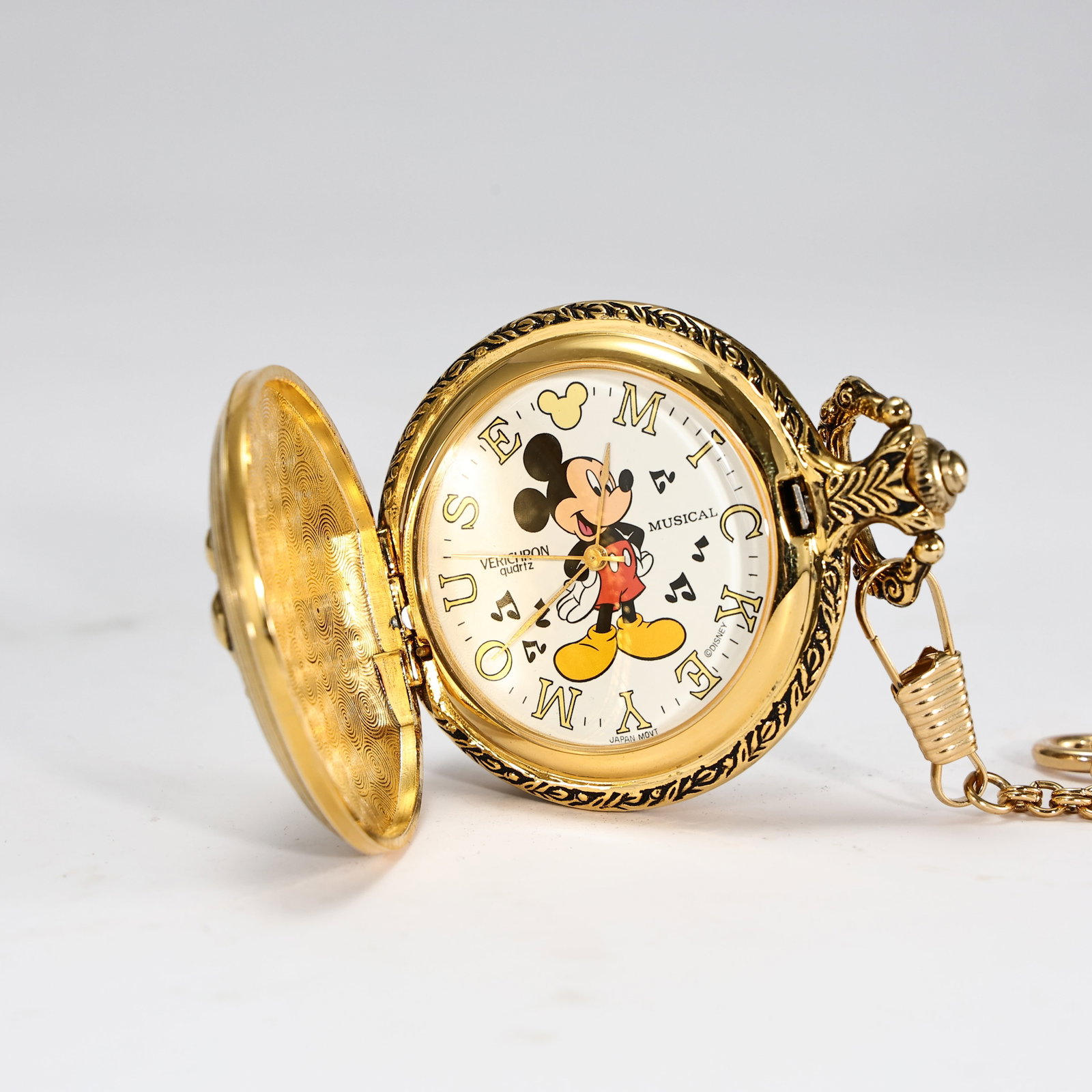 1980s Disney Mickey Mouse Musical Pocket Watch: 1980s Disney Mickey Mouse Musical Pocket Watch ( Watch: 6.5 x 4.5 x 1 cm) The dial features:* Mickey Mouse standing in the center.* The word ?MUSICAL? at approximately the 3 o?clock position.* ?VERICH