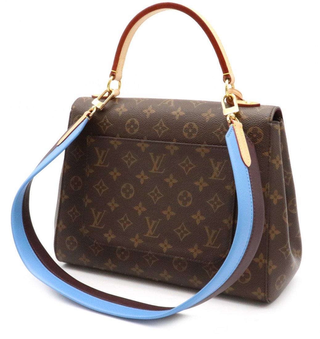 Louis Vuitton CLUNY MM: The bag’s pure, structured silhouette is timeless and the lively colour strap totally on-trend. The Cluny is practical as well, an ideal bag for business, with its top handle for hand or elbow carry